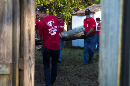 U.S. Marines and volunteers with Sheep Dog Impact Assistance organization remove tree logs from an area impacted during Hurricane Florence in Wilmington, North Carolina, U.S., September 22, 2018. Lance Cpl. Auburne D. Gipson/U.S. Marine Corps/Handout via REUTERSPARTY.