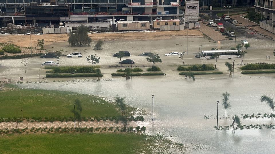 Cars drive through a flooded street in Dubai, United Arab Emirates, Tuesday. - Abdel Hadi Ramahi/Reuters
