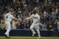 San Diego Padres' Wil Myers, right, celebrates with third base coach Matt Williams after hitting a home run during the eighth inning of a baseball game against the San Francisco Giants, Tuesday, Oct. 4, 2022, in San Diego. (AP Photo/Gregory Bull)