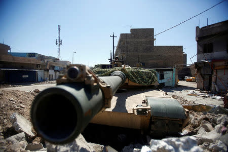 A soldier of Iraqi army sits in a tank during clashes between Iraqi forces and Islamic State militants, in Mosul. REUTERS/Khalid al Mousily