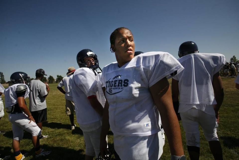 Lineman Greg Grimes of Inderkum looks back towards some friends as he stands on the sidelines at a summer camp at Inderkum high school on June 15, 2007. Grimes was shot and killed outside a nightclub at 15th and L streets in downtown Sacamento early Monday, July 4, 2022.