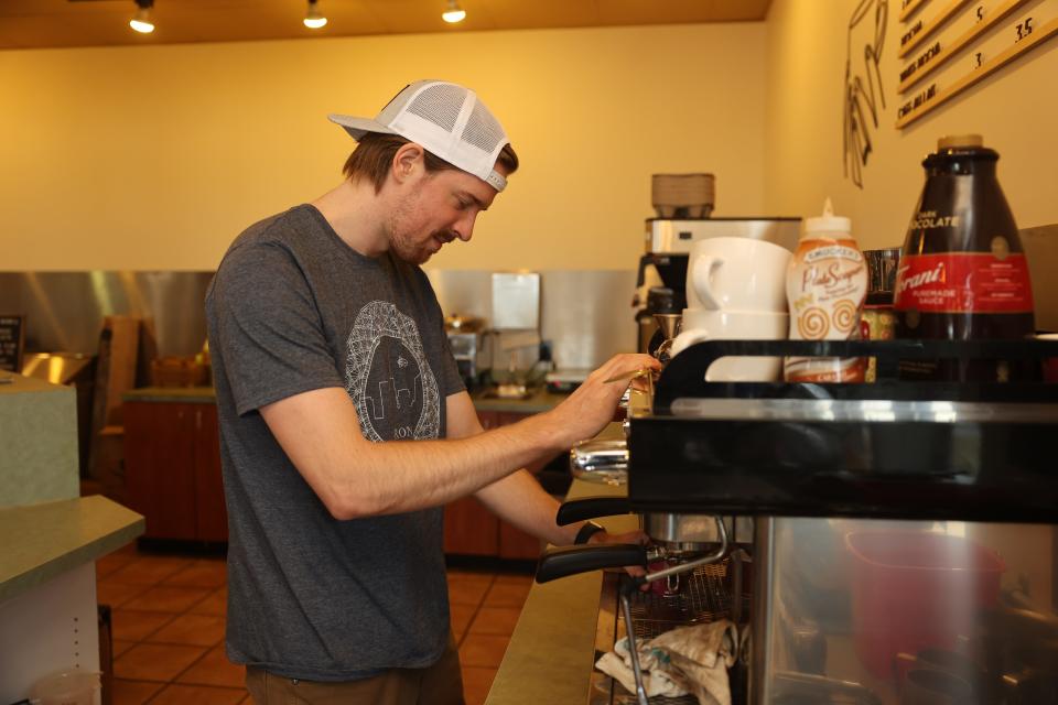 Jason Smith, co-owner of the Ocelot Café and Bakery in Richfield, prepares an espresso drink behind the counter.