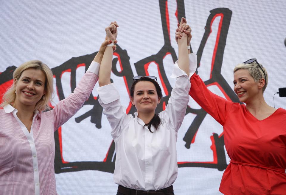 FILE - In this July 19, 2020, file photo, Maria Kolesnikova, a representative of Viktor Babariko, right, Sviatlana Tsikhanouskaya, candidate for the presidential elections, center, and wife of non-registered candidate Valery Tsepkalo, Veronika Tsepkalo, left, gesture during a meeting in support of Sviatlana Tsikhanouskaya in Minsk, Belarus. Kolesnikova, a professional flute player with no political experience, emerged as a key opposition activist in Belarus. She has appeared at protests of authoritarian President Alexander Lukashenko after he was kept in power by an Aug. 9 election that his critics say was rigged. (AP Photo/Sergei Grits, File)
