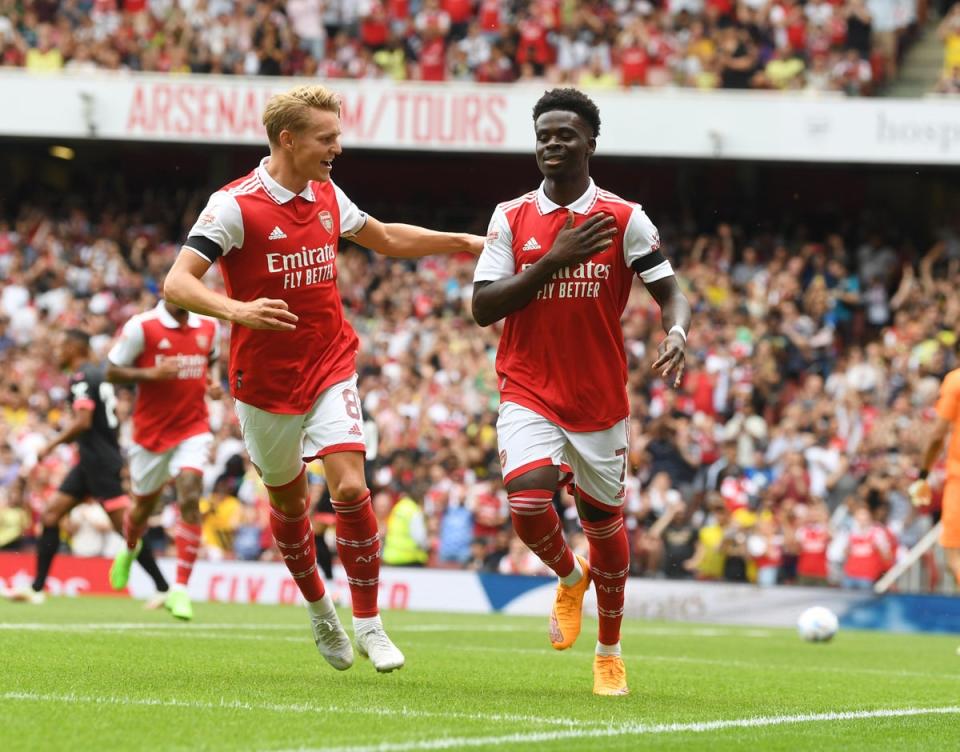 Bukayo Saka celebrates scoring with Martin Odegaard during the Emirates Cup match against Sevilla (Arsenal FC via Getty Images)