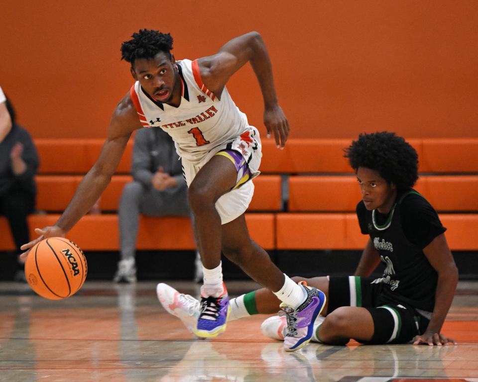 Apple Valley’s Jeremiah Wilkerson leads a fastbreak as Victor Valley’s Laeton Butler looks on during the fourth quarter on Tuesday, Dec. 5, 2023. Apple Valley beat Victor Valley 68-63 and improved to 5-0 on the season.