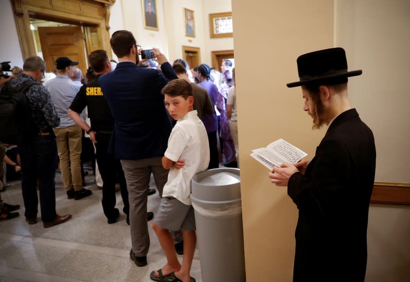 FILE PHOTO: Orthodox Jewish man supporting a religious exemption to childhood vaccinations is seen outside courtroom during hearing on religious exemption to vaccination in Albany