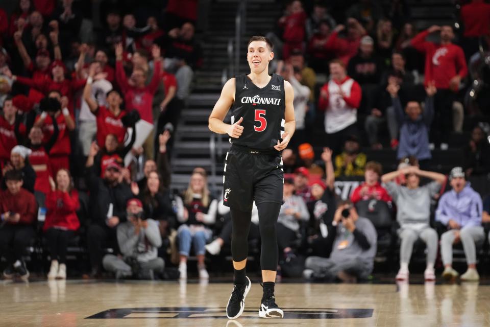 Cincinnati Bearcats guard CJ Fredrick (5) reacts to a made 3-point basket in the second half during an NCAA college basketball game between Georgia Tech Yellow Jackets and the Cincinnati Bearcats, Wednesday, Nov. 22, 2023, at Fifth Third Arena in Cincinnati.