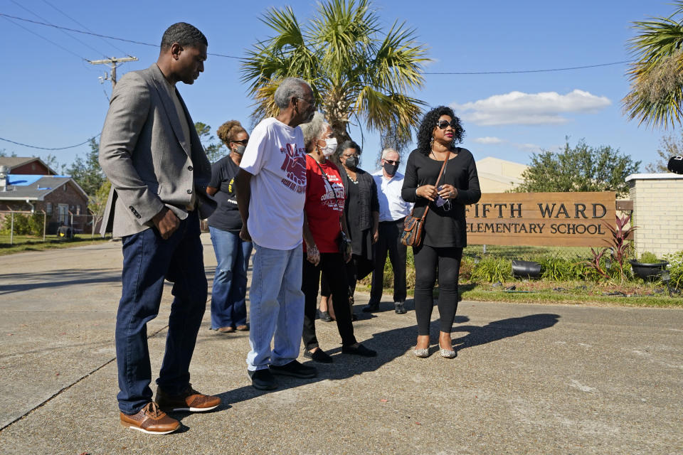 FILE - EPA Administrator Michael Regan, left, arrives at the Fifth Ward Elementary School, which is near the Denka plant, with Robert Taylor, second left, founder of Concerned Citizens of St. John's Parish, and Lydia Gerard, third left, a member of the group, in Reserve, La., Nov. 16, 2021. The EPA sued Denka Performance Elastomer LLC, arguing that its petrochemical operations in southern Louisiana posed an unacceptable cancer risk to the mostly-Black community nearby. The EPA has demanded that the company reduce toxic emissions from its plant that makes synthetic rubber. (AP Photo/Gerald Herbert, File)