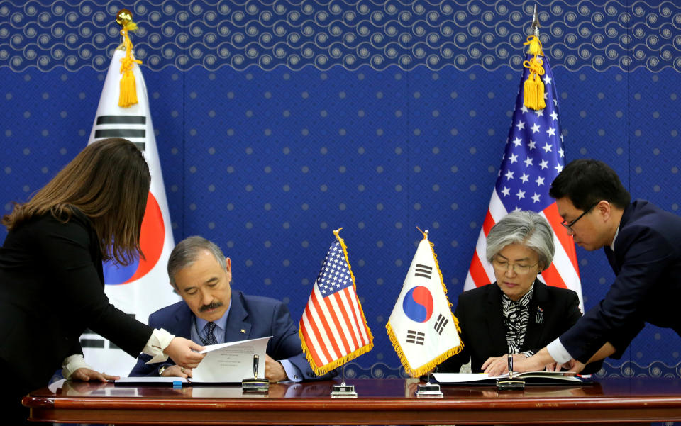 FILE PHOTO: South Korean Foreign Minister Kang Kyung-wha and U.S. Ambassador to South Korea Harry Harris, sign documents at the Foreign Ministry in Seoul