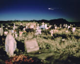 <p>“Acknowledgment of Danger”: Luis Lopez Cemetery, Socorro County, N.M., April 2, 2016. Luis Lopez is a town in one of four counties being studied for health impacts resulting from radiation fallout from the 1945 Trinity atomic test. Unlike residents of Nevada and Utah, those in New Mexico have never been acknowledged or covered under the Radiation Exposure Compensation Act. Luis Lopez residents say dozens of people in the cemetery died of cancer and wonder if it was linked to the Trinity test. Residents within 150 miles of the Trinity site show higher incidents of cancer than in other parts of New Mexico, according to a health impact study released in 2017 by the Tularosa Basin Downwinders Consortium. (© Nina Berman from “War Is Only Half the Story,” the Aftermath Project & Dewi Lewis Publishing) </p>