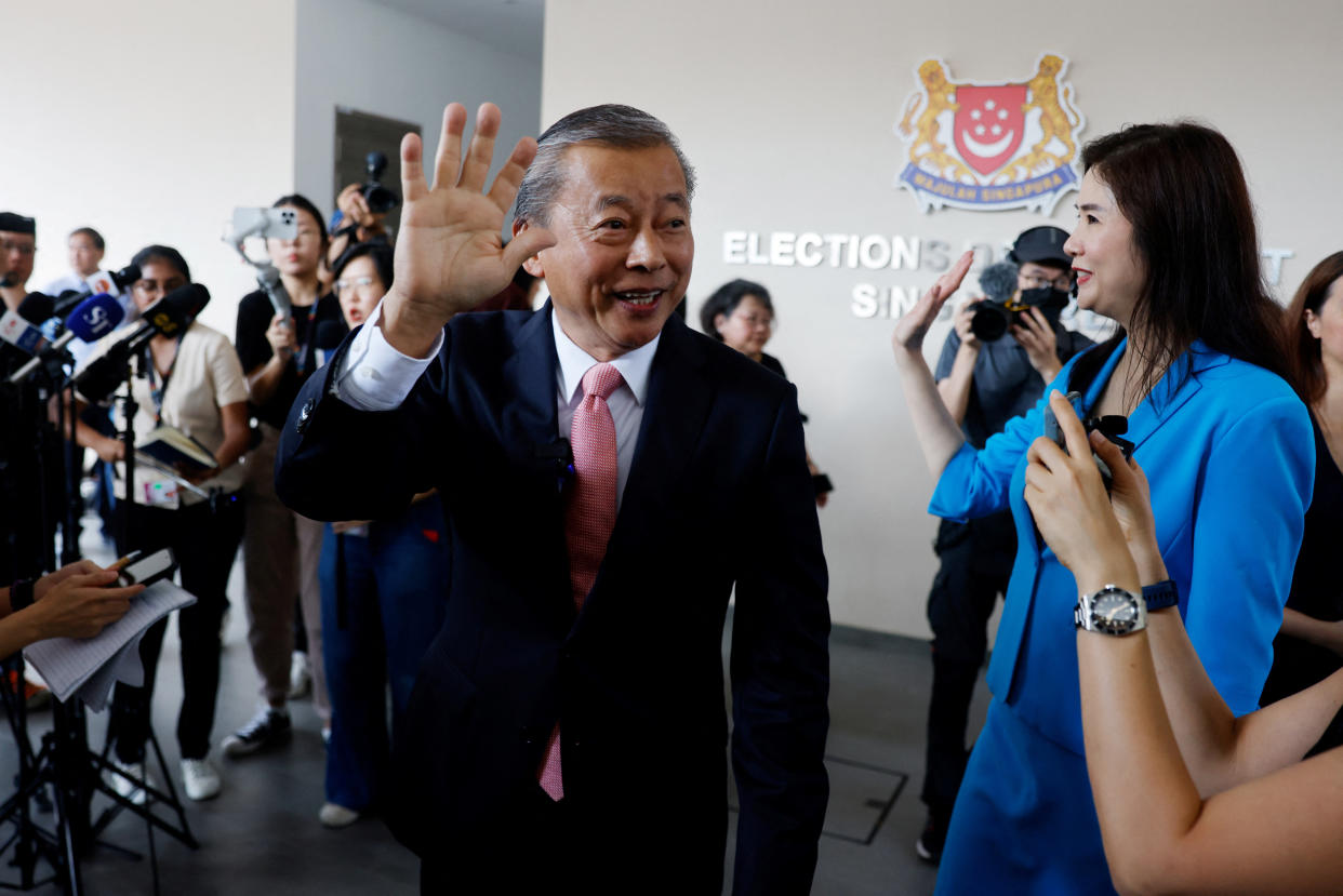 Potential presidential candidate George Goh and his wife Lysa Sumali leave the Elections Department. 