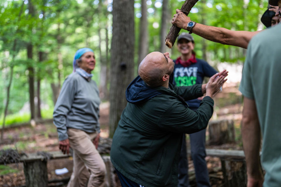 Shane Hobel demonstrates a technique for finding water in the forests of the northeastern United States. (Michael Rubenstein / for NBC News)