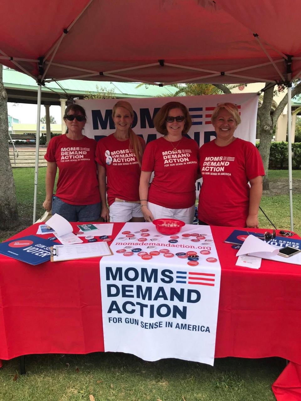 Megan Stolen, Tricia Ochipa, Connie Rooke and Melissa DeFrancesco, members of the Brevard chapter of Moms Demand Action for Gun Sense in America, are pictured at a community event in Cocoa.