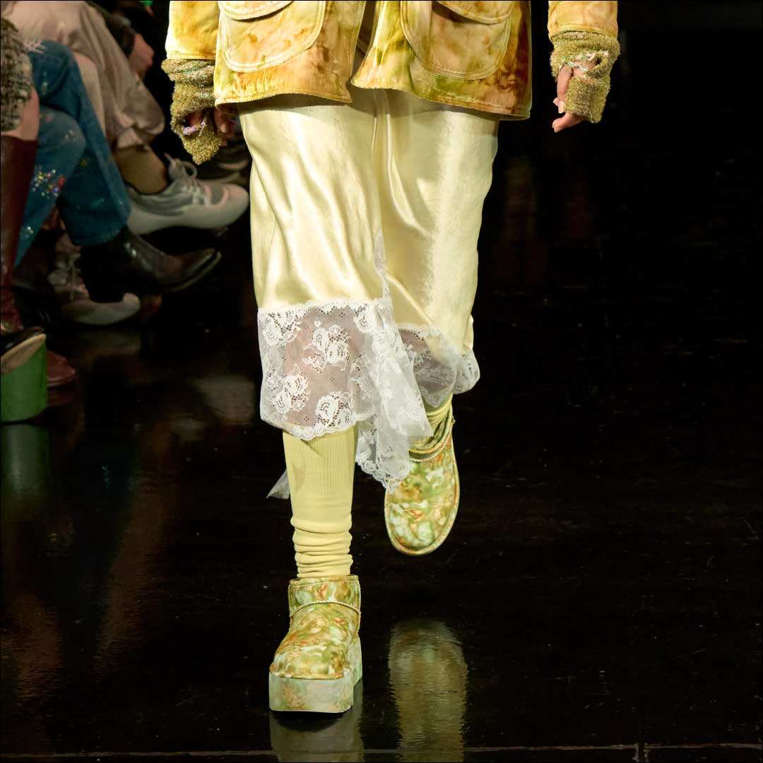  A model walks the collina strada runway wearing floral ugg boots. 