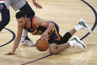 Golden State Warriors guard Stephen Curry dribbles after falling down during the first half of the team's NBA basketball game against the Washington Wizards in San Francisco, Friday, April 9, 2021. (AP Photo/Jed Jacobsohn)