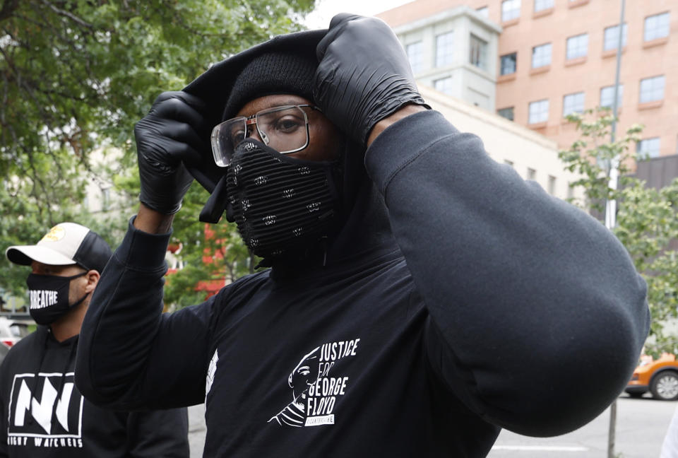 Denver Broncos linebacker Von Miller pulls up the hood on his sweater to take part in a rally with teammates in the Greek Amphitheatre in Civic Center Park over the death of George Floyd Saturday, June 6, 2020, in downtown Denver. (AP Photo/David Zalubowski)