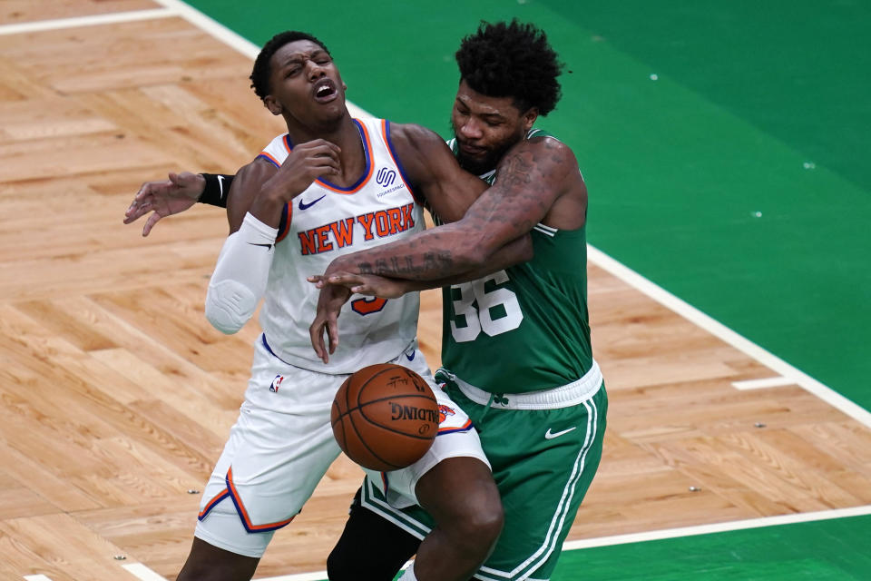 Boston Celtics guard Marcus Smart (36) fouls New York Knicks guard RJ Barrett, left, during the first half of an NBA basketball game Wednesday, April 7, 2021, in Boston. (AP Photo/Charles Krupa)