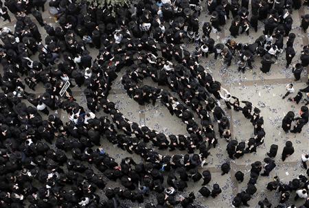 Ultra-Orthodox Jewish men dance before the start of a mass prayer in Jerusalem March 2, 2014. REUTERS/Darren Whiteside