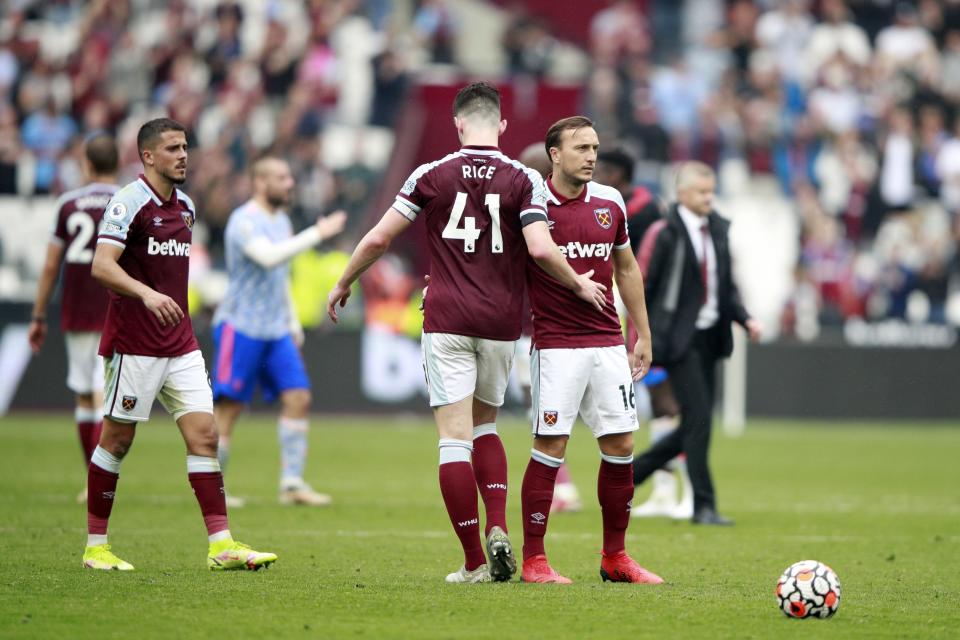 West Ham's Declan Rice, left, and Mark Noble react after the English Premier League soccer match between West Ham United and Manchester United at the London Stadium in London, England, Sunday, Sept. 19, 2021. Manchester United won 2-1. (AP Photo/Ian Walton)
