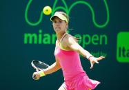 Eugenie Bouchard of Canada returns the ball to Tatjana Maria of Germany during day 6 of the Miami Open on March 28, 2015 in Key Biscayne, Florida