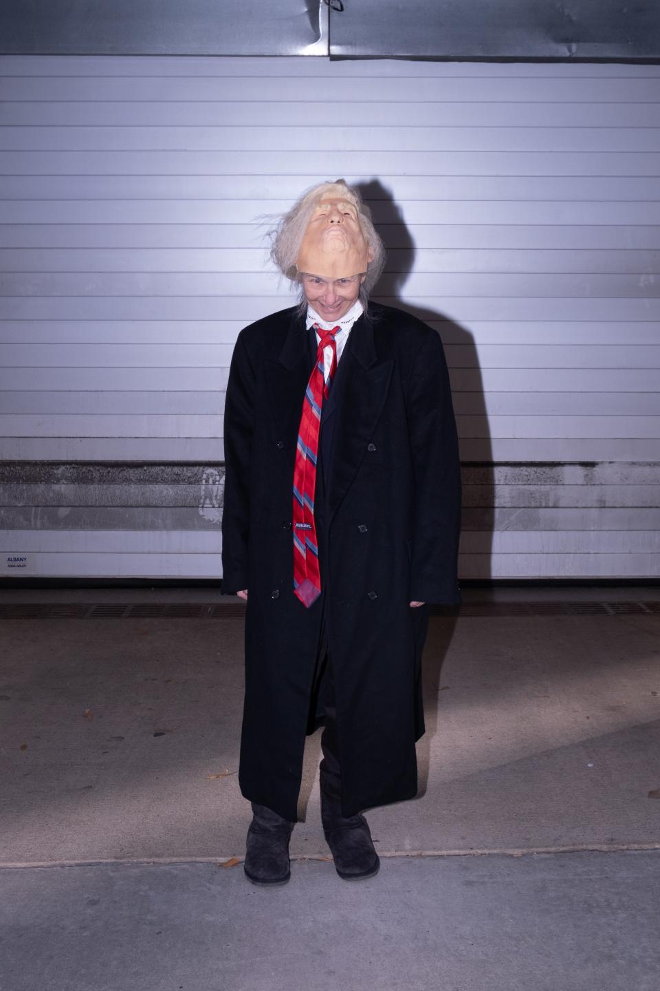 A woman dons a Trump mask and walks the empty streets of Washington D.C.