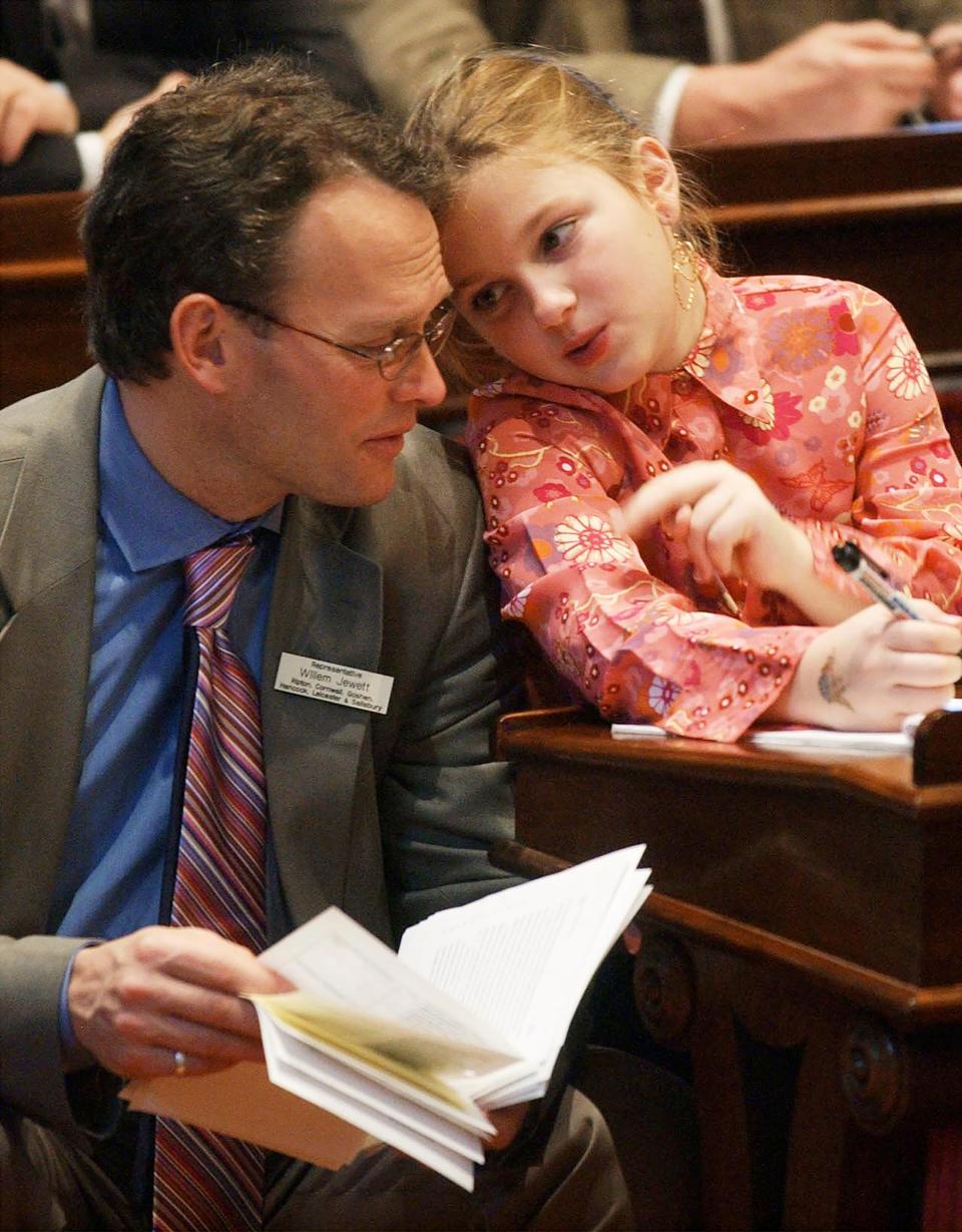 Vermont Rep. Willem Jewett, D-Ripton, chats with his daughter, Anneke, during the first day of the Legislature in Montpelier on Jan. 5, 2004. He died on Jan. 12, 2022. Jewett, who had cancer, helped pass a Vermont's aid-in-dying law that allows terminally ill patients to ask their doctors for a lethal dose of medication.