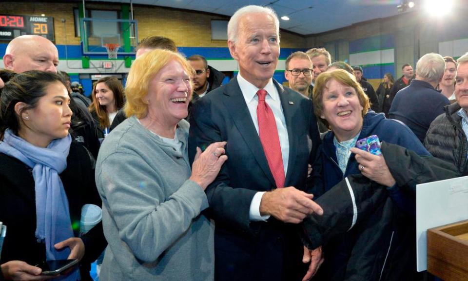 Joe Biden poses with supporters after a town hall in Franklin, New Hampshire, on 8 November.