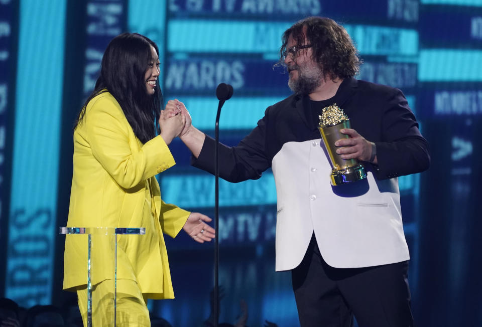 Awkwafina, left, presents the comedic genius award to Jack Black at the MTV Movie and TV Awards on Sunday, June 5, 2022, at the Barker Hangar in Santa Monica, Calif. (AP Photo/Chris Pizzello)