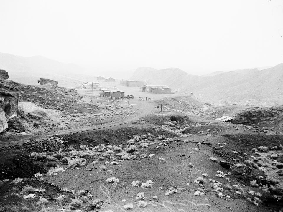 black and white photo of calico, california, with buildings in the distance
