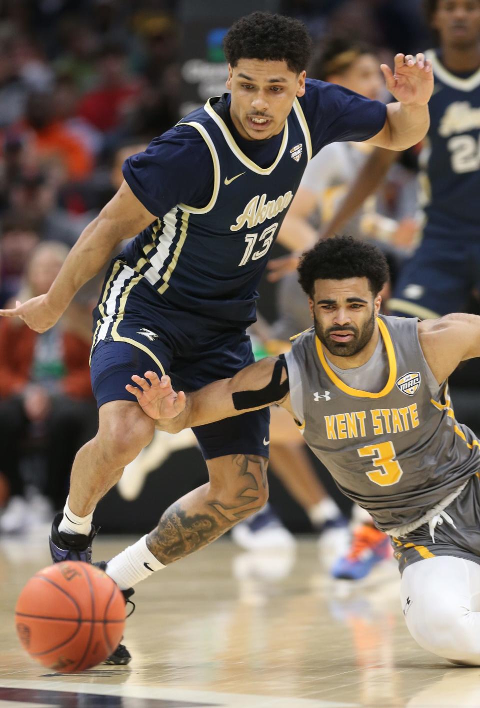 Akron's Xavier Castaneda and Kent State's Sincere Carry go after a first-half loose ball in the Mid-American Conference championship game on Saturday, March 12, 2022 in Cleveland.