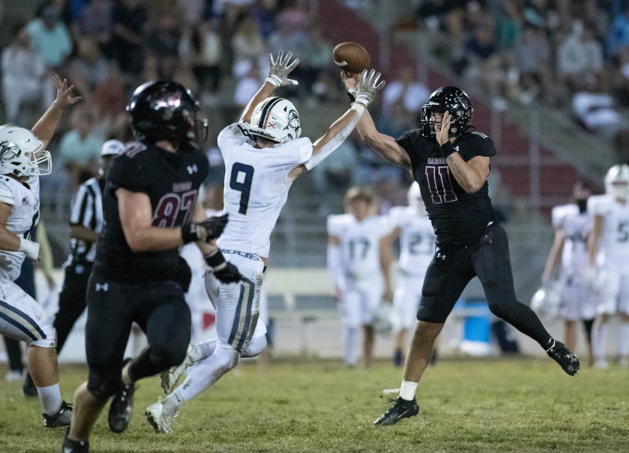 Quarterback Hunter Pfiester (11) passes during the Gulf Breeze vs Navarre football game at Navarre High School on Friday, Oct. 27, 2023.