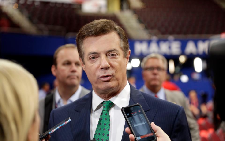 Paul Manafort talks to reporters on the floor of the Republican National Convention in July 2016 - Credit: AP