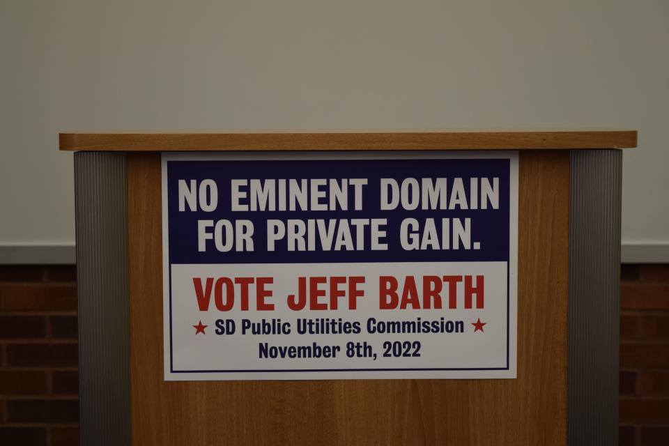 "No eminent domain for private gain" sign, part of Democrat Jeff Barth's campaigning for the South Dakota Public Utilities Commission, hangs on the podium at a Democrat press conference in the downtown Sioux Falls library on Thursday, July 28, 2022.