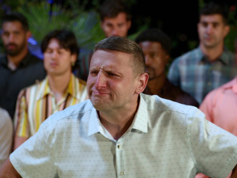 tim robinson with a comically skeptical look on his face, his hands on his hips