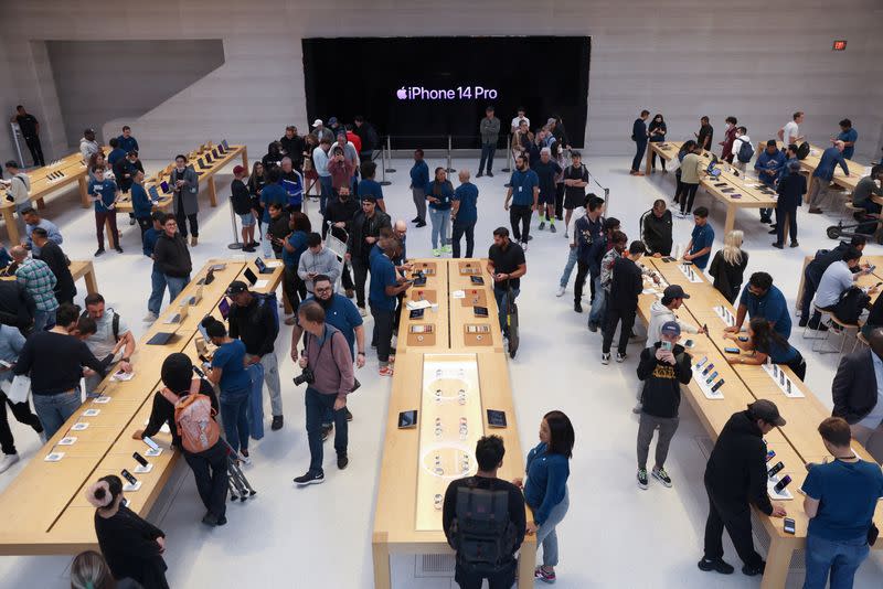 Customers shop at the Apple Fifth Avenue store for the release of the Apple iPhone 14 range in Manhattan, New York City