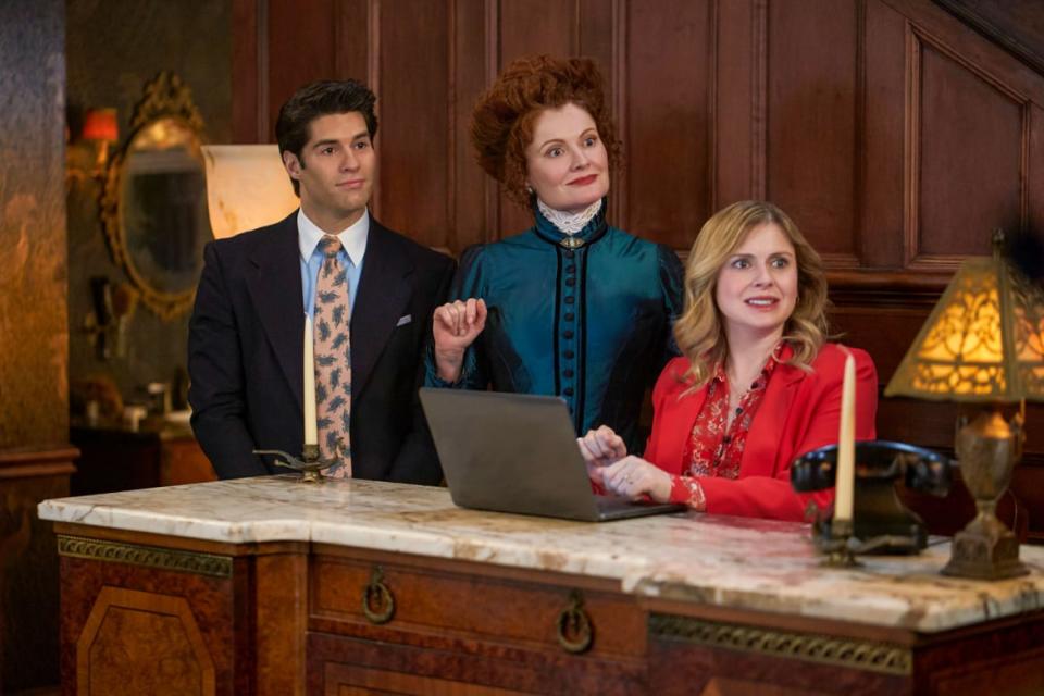 Asher Grodman, Rebecca Wisocky, and Rose McIver stand behind a desk in 'Ghosts'