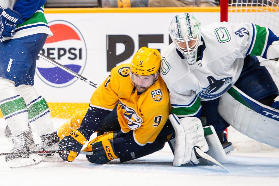 Vancouver Canucks goaltender Casey DeSmith (29) and Nashville Predators left wing Filip Forsberg (9) fight for position during the third period of Game 3.
