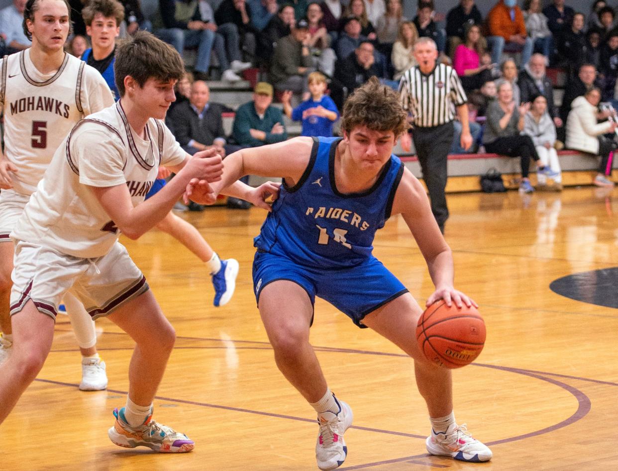 Dover-Sherborn junior Chris Kiesling is guarded by Millis High freshman Sean Ryan during the game in Millis, Jan. 31, 2023. The Raiders defeated the Mohawks, 75-60.