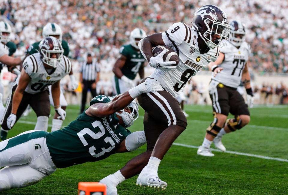 Michigan State linebacker Darius Snow (23) tackles Western Michigan running back Sean Tyler (9) during the first half at Spartan Stadium in East Lansing on Friday, Sept. 2, 2022.