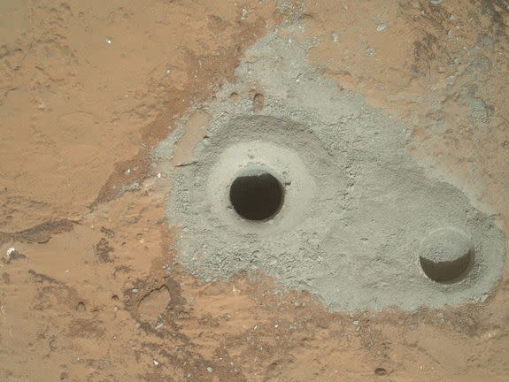 At the center of this image from NASA's Curiosity rover is the hole in a rock called "John Klein" where the rover conducted its first sample drilling on Mars. The drilling took place on Feb. 8, 2013, or Sol 182, Curiosity's 182nd Martian day o