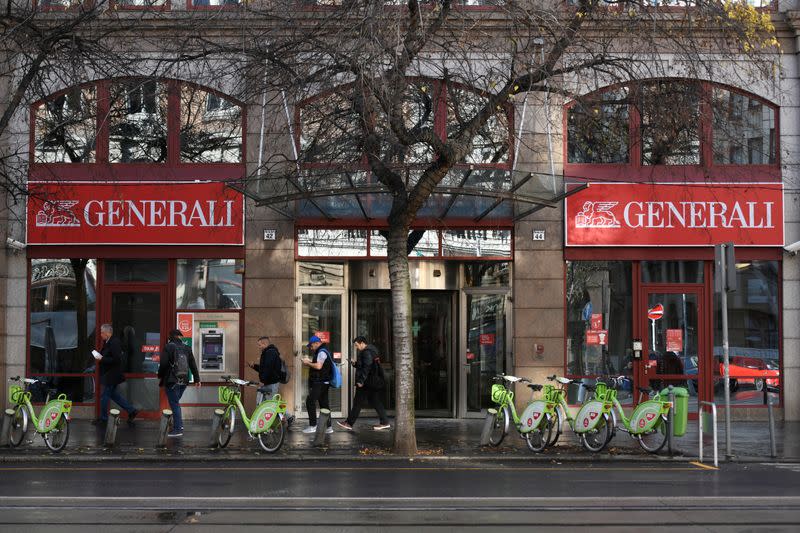 People walk past the headquarters of insurance company Generali in Budapest