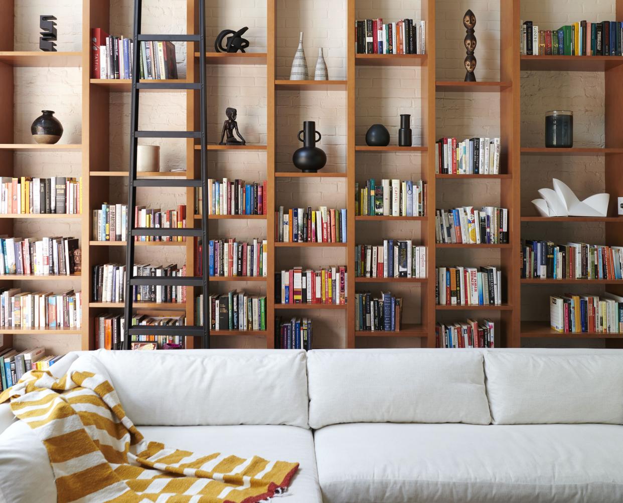  A living room with a built in library . 