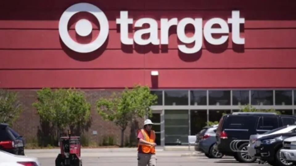 A worker collects shopping carts in the parking lot of a Target store in June 2021 in Highlands Ranch, Colorado. Target is pulling a Black History Month product from its shelves after incorrectly identifying Black icons. (Photo: David Zalubowski/AP, File)