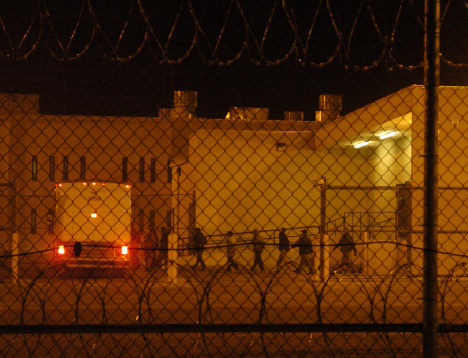 Migrants are loaded onto a bus early in the morning in 2006 at the Val Verde Correctional Facility in Del Rio, Texas. The migrant inmates were being taken to a courthouse to face criminal immigration charges. (Photo: RJ Sangosti via Getty Images)