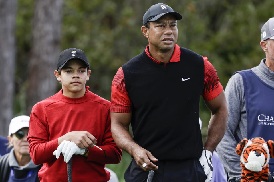 Tiger Woods, right, and his son Charlie Woods, left, prepare to tee off on the 3rd hole during the final round of the PNC Championship golf tournament Sunday, Dec. 18, 2022, in Orlando, Fla. (AP Photo/Kevin Kolczynski)