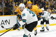 San Jose Sharks center Logan Couture (39) reaches for the puck as Nashville Predators center Ryan Johansen (92) closes in during the first period of an NHL hockey game Tuesday, Oct. 26, 2021, in Nashville, Tenn. (AP Photo/Mark Humphrey)