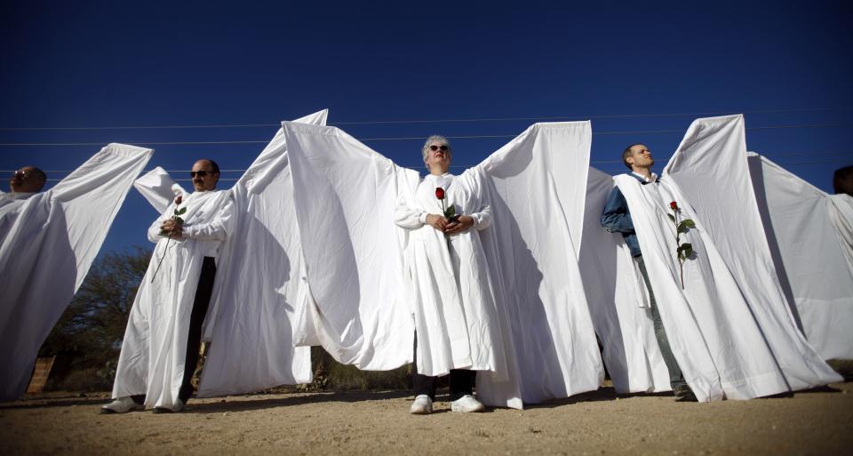 Volunteers from the Angel Project stand guard outside Christina-Taylor Green’s funeral. After the attack, the Westboro Baptist Church threatened to picket outside the 9-year-old’s memorial service, proclaiming that God had sent the shooter to punish the liberal congresswoman and her supporters. (Rick Wilking/Reuters)