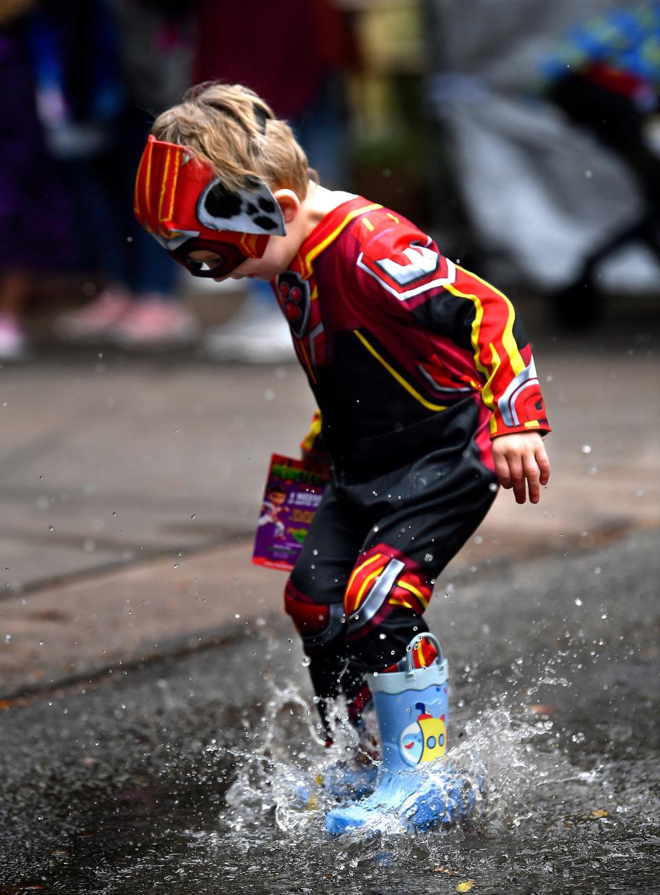 Kaladin Ambrose, 3, tests the durability of a puddle while visiting the Abilene Zoo Saturday with his mother Jessica during Boo at the Zoo.