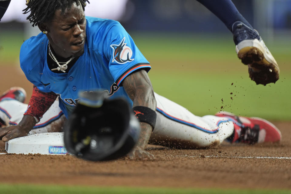 Miami Marlins' Jazz Chisholm Jr. slides into third safely during the first inning of a baseball game against the Seattle Mariners, Sunday, June 23, 2024, in Miami. (AP Photo/Wilfredo Lee)