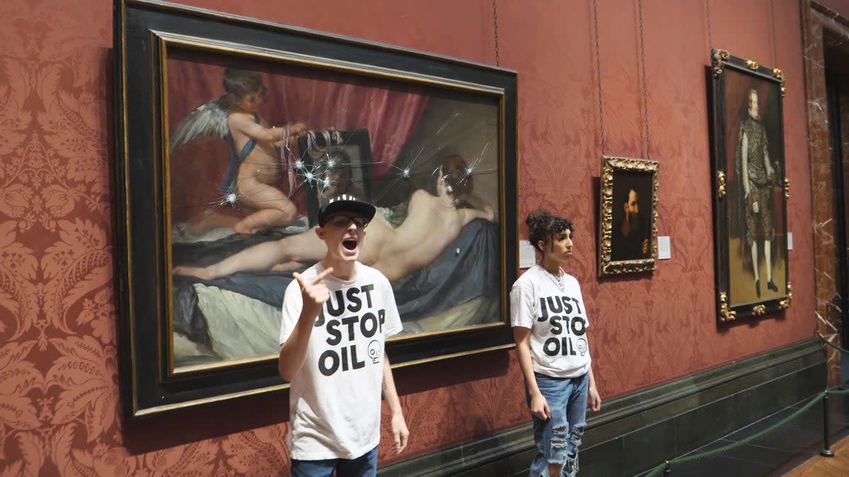 Just Stop Oil activists after smashing the protective panel over The Rokeby Venus at the National Gallery in London (AP)